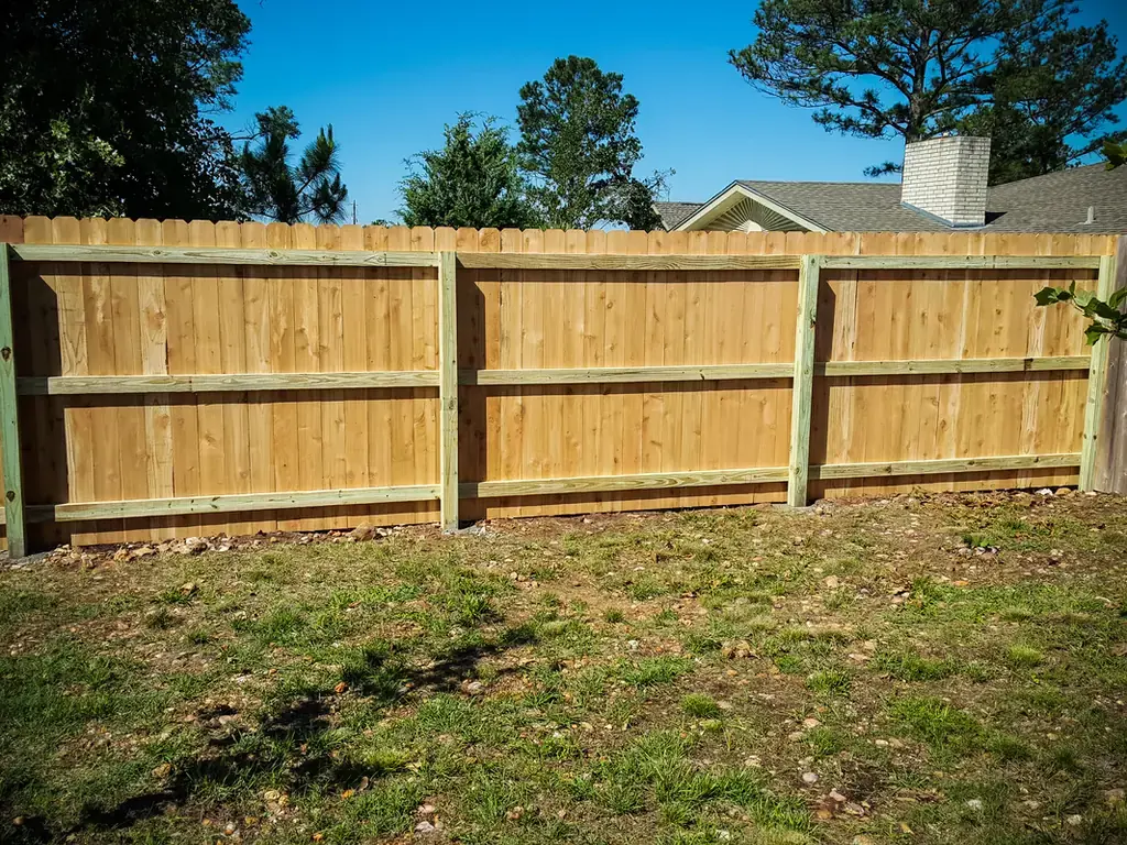 Completed cedar privacy fence installation along the boundary of a San Antonio residential property