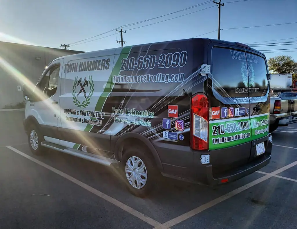 Twin Hammers Roofing and Contracting branded box van showing the phone number, free estimates, financing available, and GAF and BBB Accredited Business badges